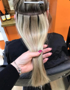 Tape in hair outlet extensions in a ponytail